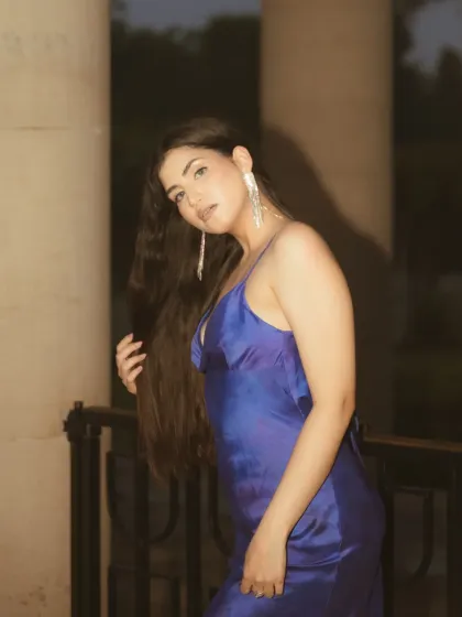 A close-up from the same night session, focusing on the subject's expression. The warm tones from the flash and the dark background create an intimate and engaging portrait.