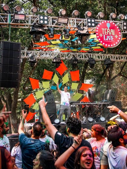A wide shot showing the impressive stage setup and the huge crowd at the palace grounds.