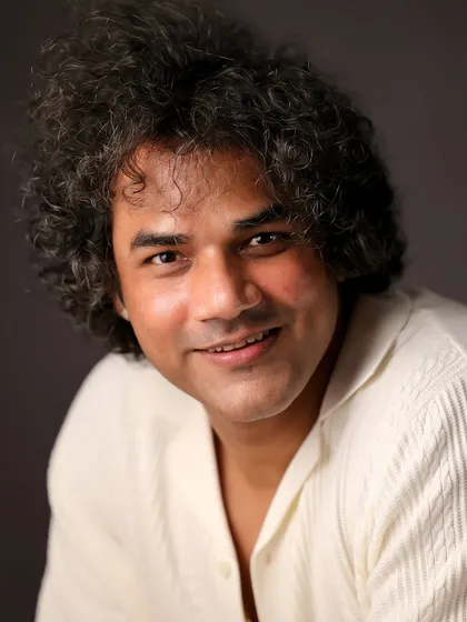 A friendly and approachable headshot of actor Alok Singh. This clean, well-lit portrait is a staple for any actor's portfolio.