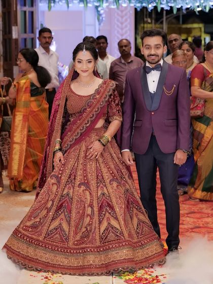 The couple walking down the aisle at their reception. The bride's makeup is designed to be visible and beautiful, even from a distance.