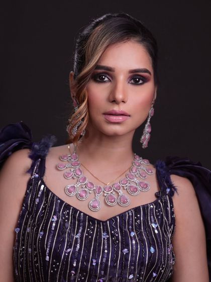 A full view of the stunning purple gown and matching jewelry.