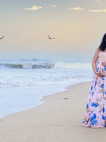 A peaceful moment for this couple on the sand, looking out at the ocean as they contemplate their new beginning.