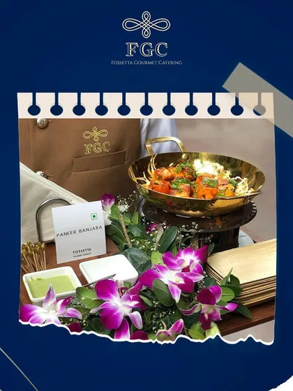 A close-up of the Paneer Banjara appetizer, highlighting the vibrant colors of the dish and the beautiful purple orchids used in the tray decoration.