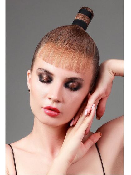 A serene, eyes-closed pose from the same editorial shoot, focusing on the dramatic eye makeup.