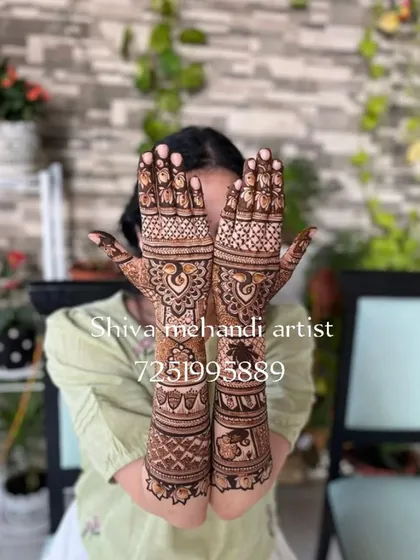 A classic and elegant full-sleeve bridal mehendi. This design focuses on traditional Indian motifs, with majestic peacocks on the palms and a royal elephant figure on the forearm, all tied together with intricate patterns.