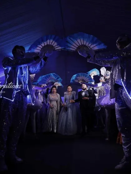 The performers create a stunning archway with their illuminated fans for the couple to walk through. It's these small, choreographed details that make an entrance truly special and unique.