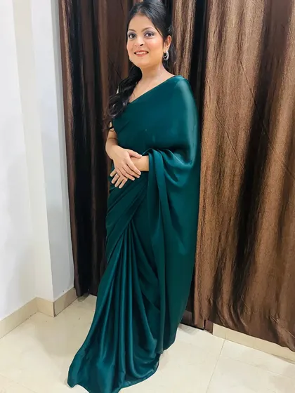 A full-length view showing how the simple, elegant hairstyle complements the satin saree. This is a perfect example of a timeless party look.