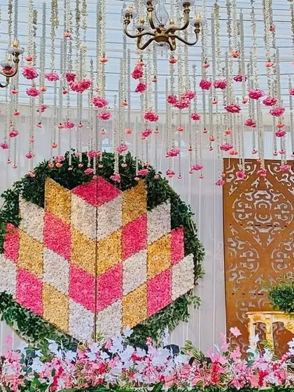A wider view of the geometric floral backdrop, showing the elegant side tables and the overall pastel color scheme.