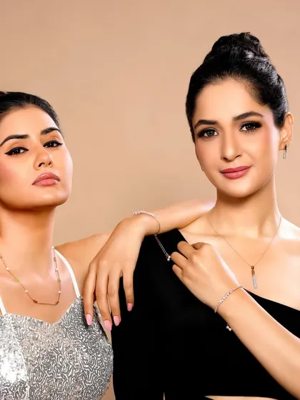 Two models pose together wearing contemporary, minimalist jewellery. This shot is great for campaigns targeting a modern, urban audience and can be used to show collection versatility.
