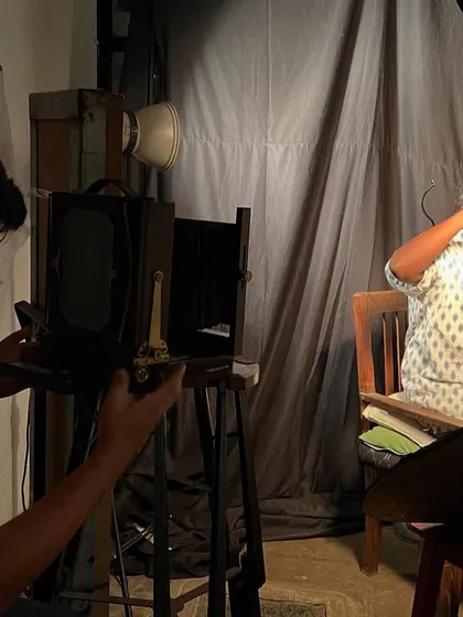 Your portrait session is a slow, deliberate experience. Here, I am working with a client in the studio, using a large format vintage camera to compose the shot. It's a collaborative process, far from the rush of digital photography.