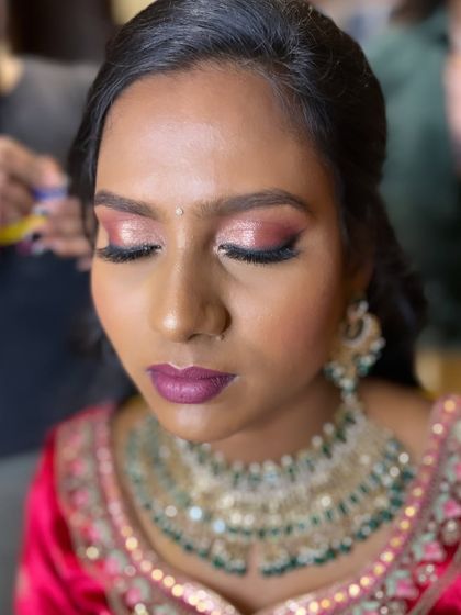 A close-up of this stunning pink shimmery eye look for a reception. Paired with a deep pink lip, it's a glamorous and modern choice.