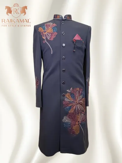 A modern sherwani-style Indo-Western piece in a dark grey, adorned with colorful floral embroidery. This is a perfect fusion of desi roots and global trends.