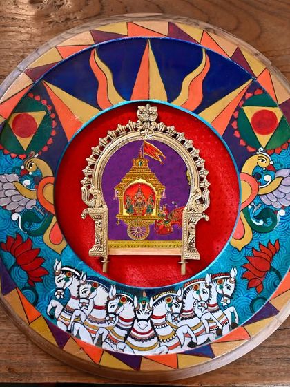 The completed Surya (Sun) frame, a hand-painted homage on a restored vintage clock frame. The artwork is rich with Vedic symbolism, featuring honey-colored eyes, a royal chariot, and lotus flowers, all framed within a vintage Prabhavali.