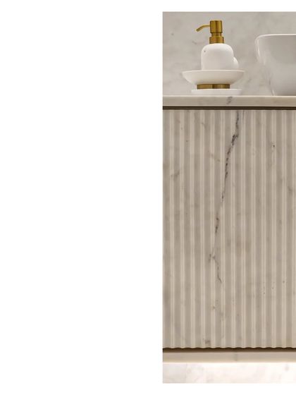 A close-up of a fluted marble vanity. The big ideas and the minute details, the craft, the thought, and the scale, must all work together to tell the tale of the space.