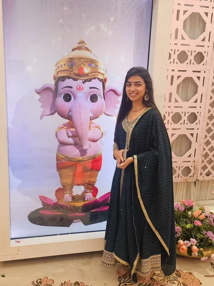 Posing with a beautiful Ganpati idol at a Ganpati Mahotsav. These festivals are close to my heart, and I love creating a devotional atmosphere with my music.