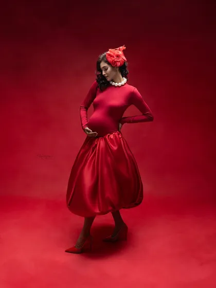 Red on red captures the fierce power within a woman's soul. This look reflects the strength of a mother and the boundless love she has for her baby.