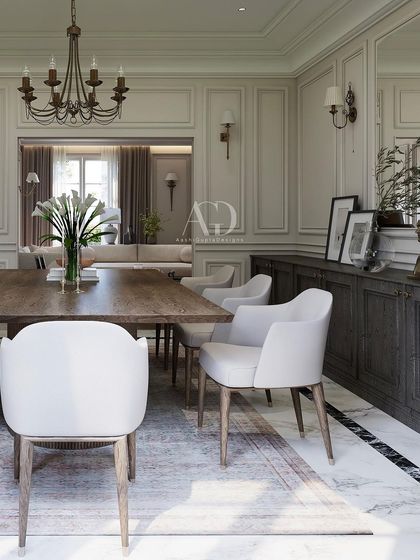 A simple yet profoundly elegant dining setup. The solid wood table and contemporary upholstered chairs are set against a backdrop of classic wall paneling, creating a space that is both modern in its simplicity and classic in its proportions.