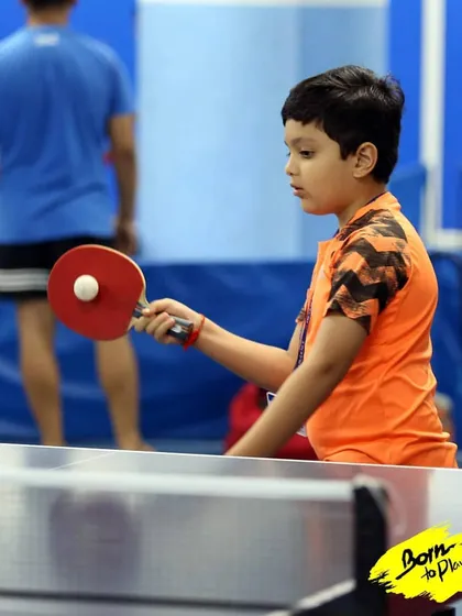 A young player focuses intently on serving the ball. The serve is the only shot you have complete control over, and we spend time perfecting different types of serves.