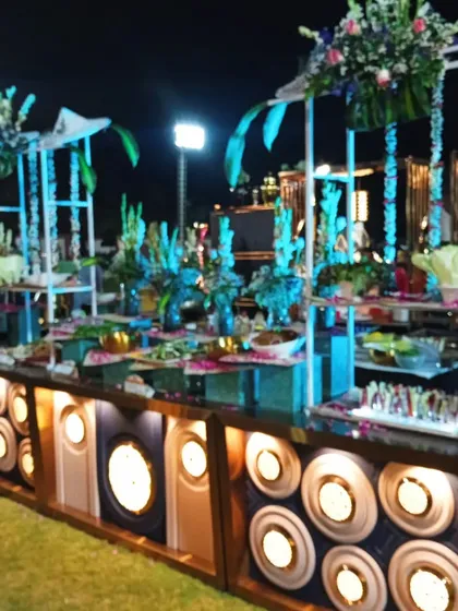 A close-up of the illuminated, multi-level salad bar, highlighting the variety of fresh salads and appetizers available for guests.