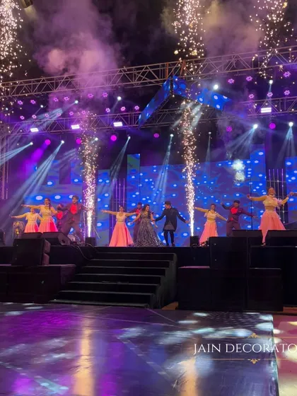 The energy of the sangeet night is captured in this shot. With pyrotechnics, a fully lit stage, and professional dancers, the decor and production come together to create an unforgettable show.