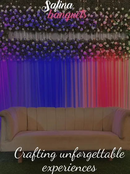 A simple yet elegant stage with a floral backdrop and colorful lighting, showcasing our ability to craft unforgettable experiences.