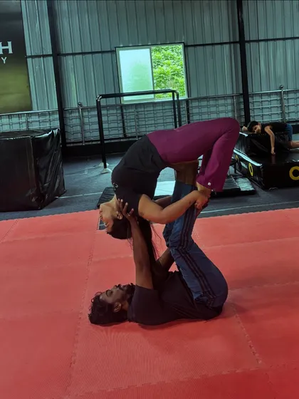 Finding harmony and balance in a beautiful acro yoga pose. This requires trust, strength, and communication.