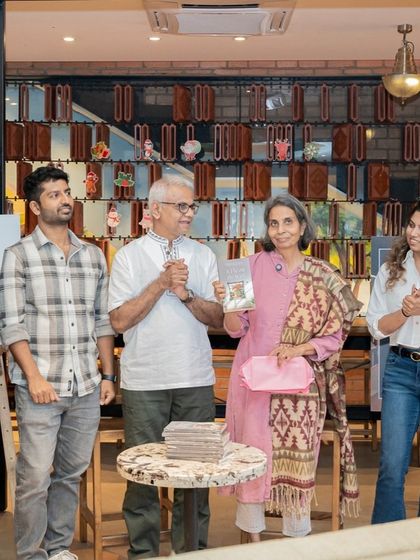 The official book unveiling for "A Fly on The Wall," with author Mini Menon surrounded by her supporters.
