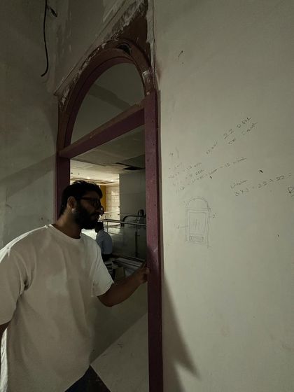 Sketching ideas directly on the wall during the construction phase. Every corner of the new store was planned with the client experience in mind.