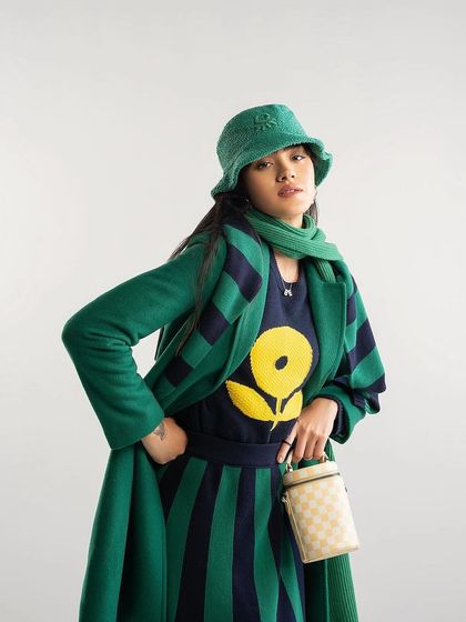A layered green and navy look from Benetton's AW'23 collection, demonstrating playful and bold styling.