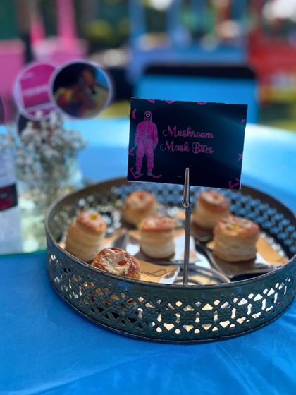 'Mushroom Mask Bites' served on a tiered platter. These savory puff pastries are another example of how I creatively name and design dishes to perfectly match the event's theme.