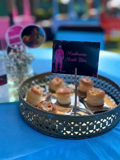 'Mushroom Mask Bites' served on a tiered platter. These savory puff pastries are another example of how I creatively name and design dishes to perfectly match the event's theme.