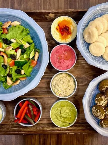 Our most popular Mezze Platter, loved by our customers. It includes pita bread, falafel, classic hummus, beetroot hummus, baba ghanoush, pesto hummus, pickles, labneh, and fattoush salad.