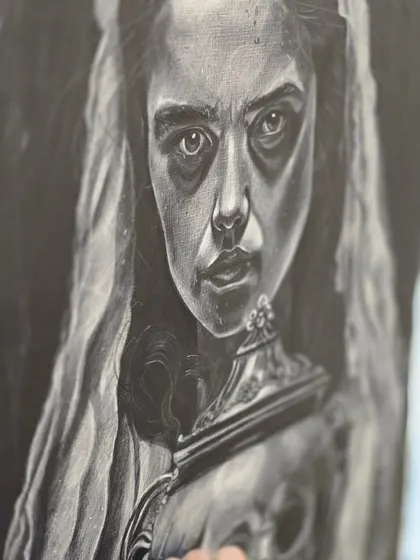 A close-up of the intense and haunting face in the charcoal drawing, highlighting the artist's skill in conveying emotion through shading and contrast.