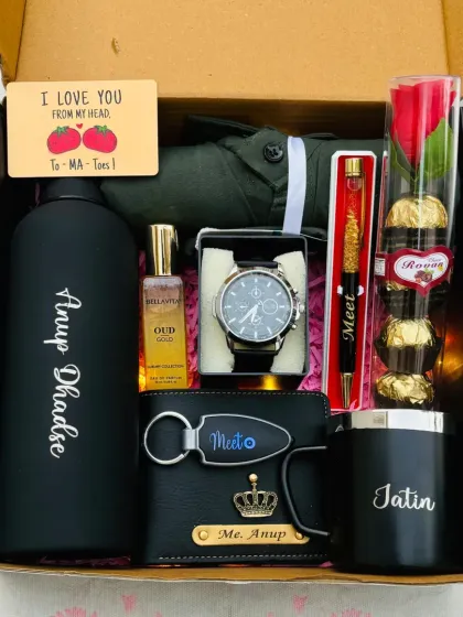 This all-black themed hamper is perfect for the man who loves a sleek look. It contains a personalized bottle, mug, and wallet, along with a watch, perfume, pen, and a Ferrero Rocher bouquet.