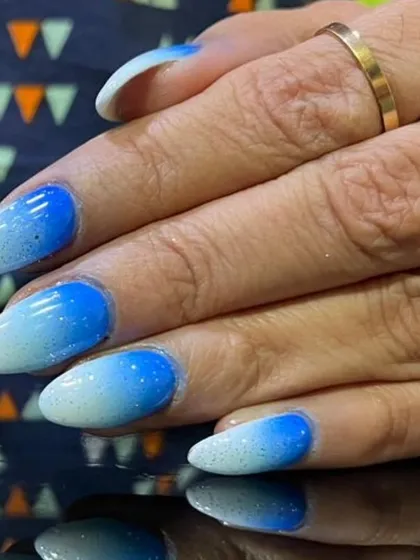 A close-up of the blue and white glitter ombre, highlighting the shimmering particles within the polish.