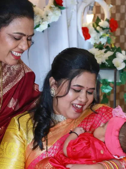 A beautiful multi-generational photo from a naming ceremony, with a grandmother looking on as the new mother holds her baby. It’s a touching portrait of family love.