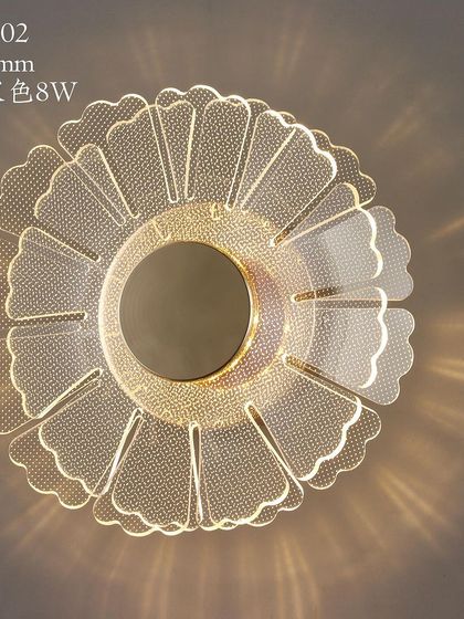 A flower-shaped wall or ceiling light with a beautiful acrylic design that scatters light in a decorative pattern.