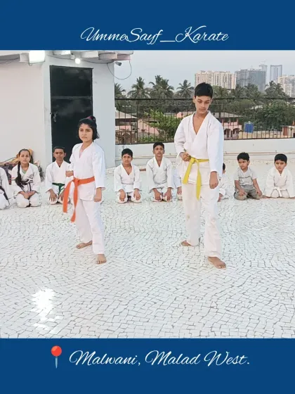 Students performing Kata on the rooftop dojo in Malad West. You can see the focus and precision in their stances as they move through the sequence together.