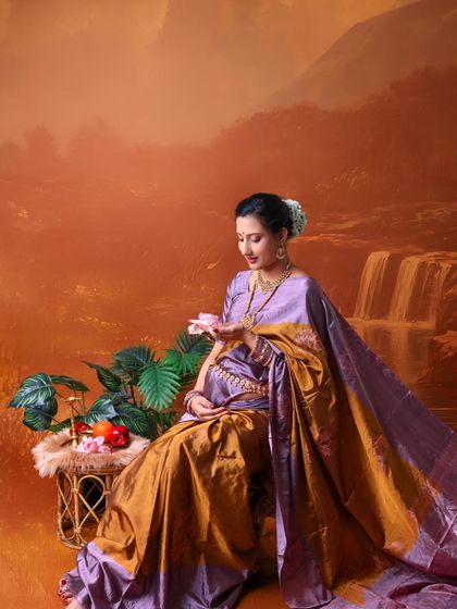 A peaceful moment captured in a traditional setting. The painted waterfall backdrop and the soft pose create a tranquil and artistic portrait.
