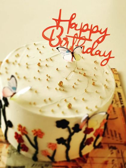 This hand-painted butterfly and floral cake was made for a special mom's birthday. It's a rich chocolate cake with dark chocolate ganache, decorated with edible paint and delicate butterfly toppers.