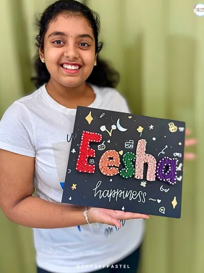 From a blank board to a personalized masterpiece. This young artist is beaming with pride after finishing her custom string art nameplate. Our workshops are designed to build confidence and give everyone a chance to express their unique style.