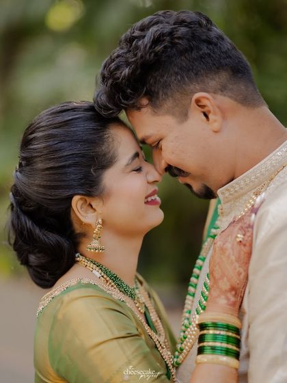A sweet, nose-to-nose moment between the couple, full of smiles.