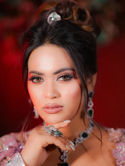 Because elegance never goes out of style. A close-up portrait showing the sharp, defined eye makeup and the overall polished feel of this party look.