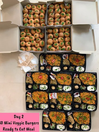 Mini veggie burgers and ready-to-eat meal plates prepared for day 2 of an exhibition.