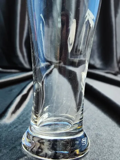 A tall pilsner glass, designed to showcase the color and carbonation of lagers and other light beers. Available as part of my glassware rental service.