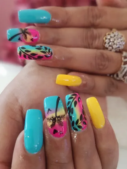 This vibrant, hand-painted tropical beach scene on long square extensions shows the level of detail I love to create. It combines a sunset gradient, silhouette palm trees, and leafy patterns for the perfect vacation-ready manicure.