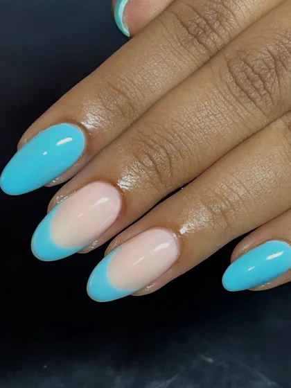 A fresh and modern French manicure using a bright sky blue for the tips.