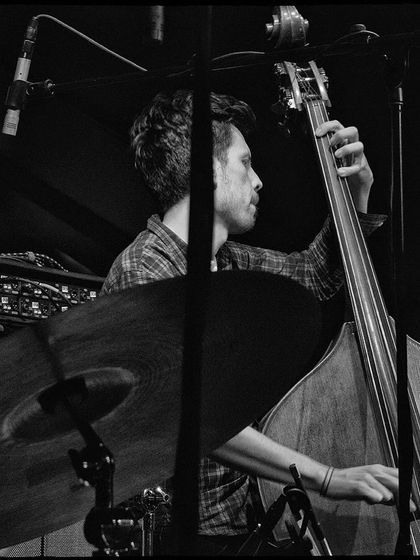 A black and white shot of our bassist at the Nublu concert. The focus is entirely on him and his instrument, highlighting his incredible skill.