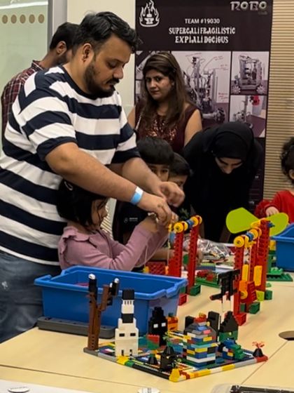 A family collaborates on a colorful LEGO creation at one of my workshops. These events are designed to be fun and educational for both children and their parents.