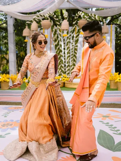 A fun, candid moment from the Haldi ceremony. The bride's makeup is designed to be long-lasting and picture-perfect, even through all the dancing.